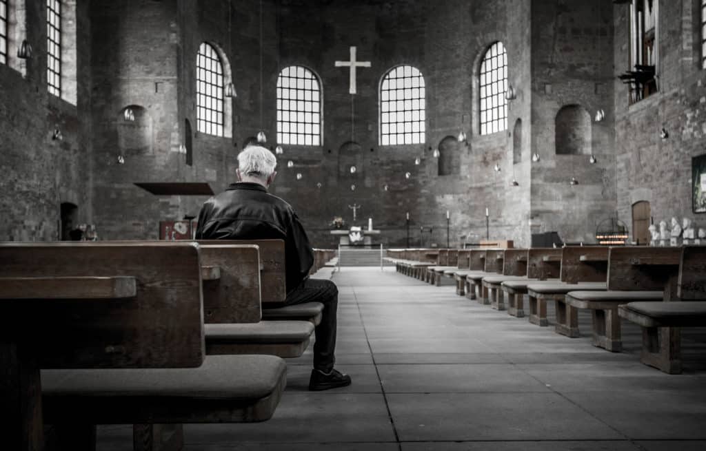 Man in church alone crop