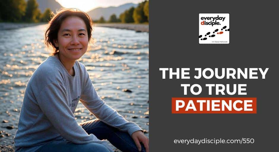 A woman with short hair wearing a gray sweatshirt smiles gently while sitting by a river during golden hour, with sunlight sparkling on the water and mountains in the background.