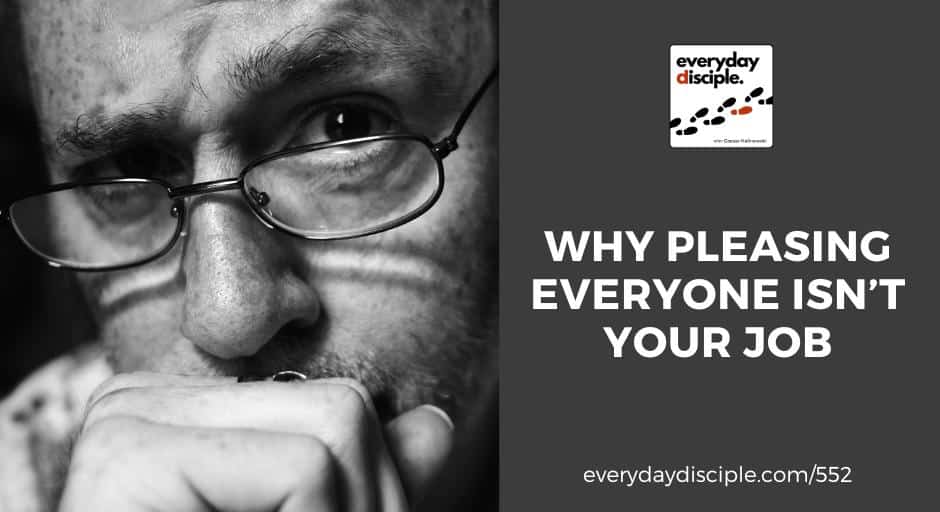 A close-up black-and-white photo of a worried man wearing glasses, resting his face on his hand in deep thought.