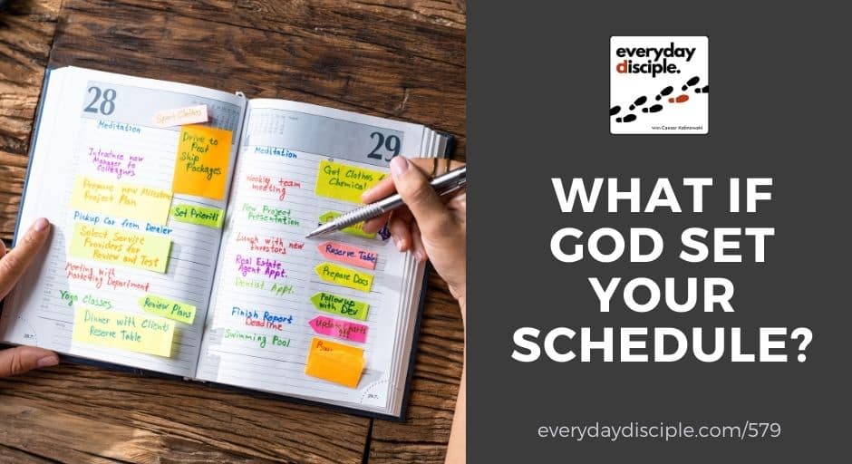A person reviews a detailed daily planner covered with notes and reminders.